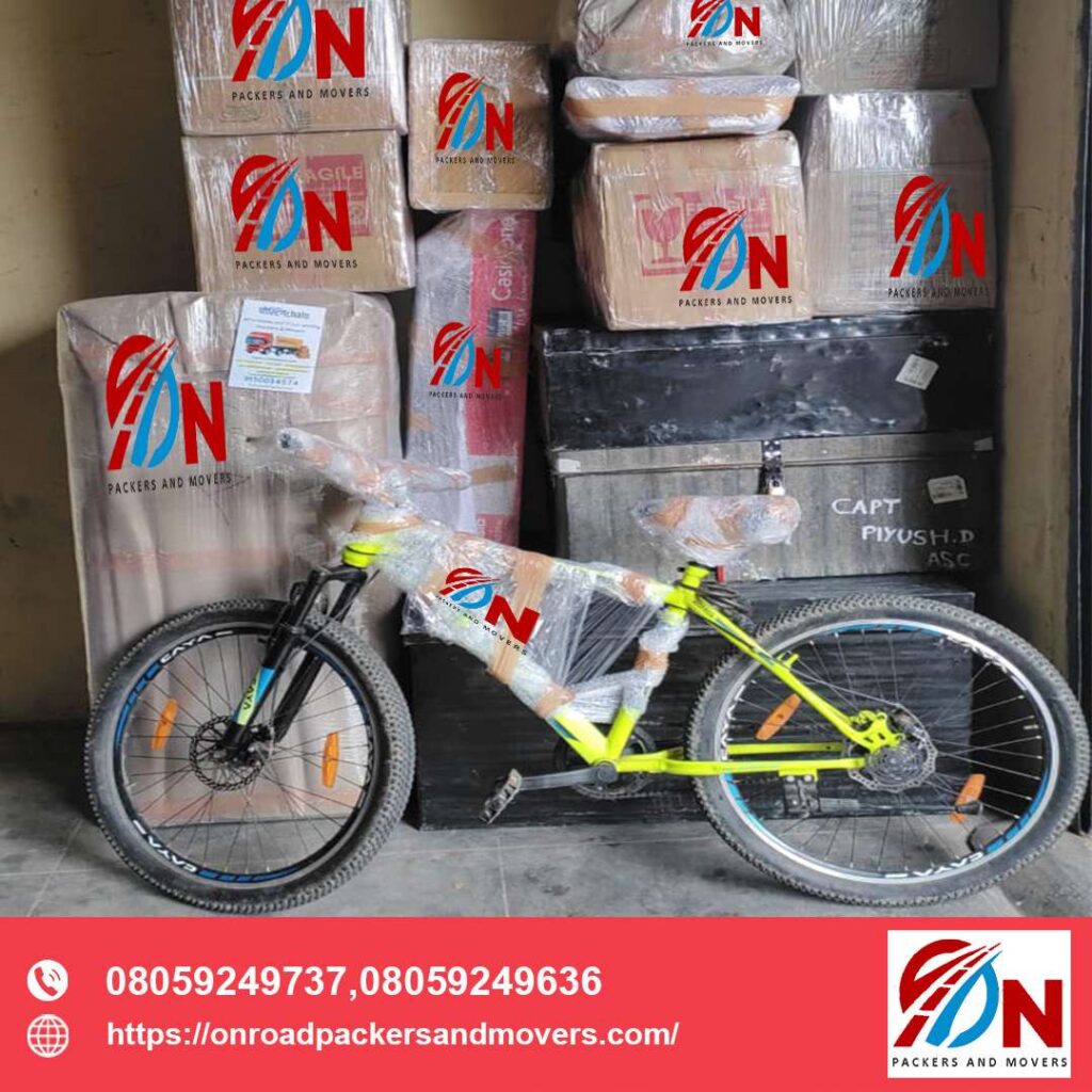 properly packed yellow cycle with goods packed in cardboard box of On Road Packers And Movers In Bangalore
