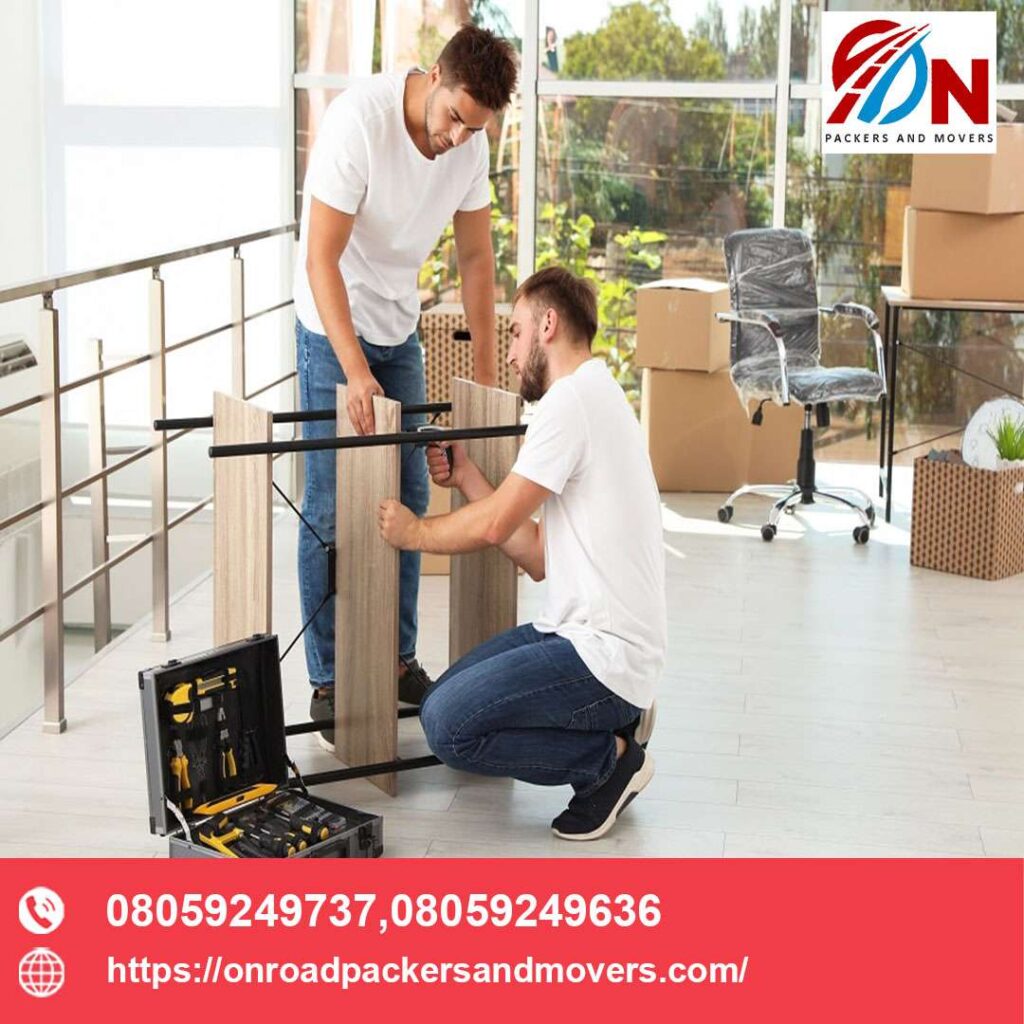 two employee disassembling furniture for making it ready for movers and packers bangalore service